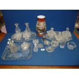 Three glass dressing table trays together with assorted glass dispensers, candle holders,