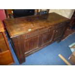 An early peg-joined Oak Coffer/Blanket Chest having three panel front with fluted frieze over,