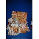 A wicker basket and a quantity of tie-backs, tassels, braiding and curtain fittings.