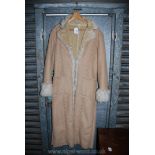 A lady's long sheepskin Coat, light beige, size 44.