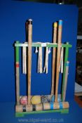 A vintage child's Croquet set on wooden stand, with four mallets,