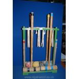 A vintage child's Croquet set on wooden stand, with four mallets,