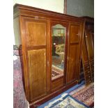A cross banded and dark and lightwood strung, Mahogany Wardrobe with generous hanging space,