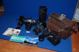 A Canon AL -1 35 mm SLR camera, Canon 35-50 mm zoom and 28 mm lenses,