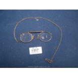 A yellow metal Pince-Nez and Chain, chip to lens.
