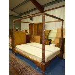 A mixed hardwood Four poster Double Bedstead having turned and mirrored spirally decorated posts,