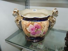A Victorian Jardiniere in blue and gold with rose pattern and dragon handles,