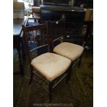 A pair of Mahogany framed spindle back Side Chairs having turned legs and stretchers,