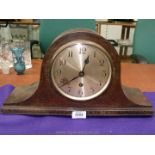 An Oak finished Napoleon's hat shaped Mantel Clock, the face having Arabic numerals,
