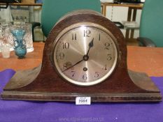 An Oak finished Napoleon's hat shaped Mantel Clock, the face having Arabic numerals,