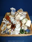 A wicker tray of small jugs, Crested ware, Royal Worcester Palissy, Blue and white Delft beaker,