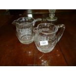 A pair of graduated Stuart crystal jugs.