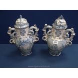 A pair of blue and white Maiolica lidded Urns with coiled handles,