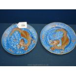 A pair of hand painted Plates having embossed dragons, 7 1/2" diameter,