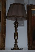 A large brass Lamp, 30" tall, with shade.