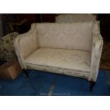 An elegant two seater Sofa, upholstered in cream shadow scrolling foliage pattern satin type fabric,