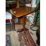 A circa 1900 rectangular snap-top Occasional Table standing on turned pillar with three pirouette
