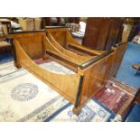 A pair of Satinwood and Mahogany single Bedsteads having ebonised details,