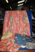 A box of mixed curtains,fabrics in orange with birds and blue chintz.