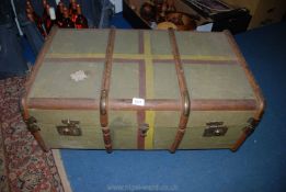 A large canvas, wooden bound Trunk with brass corners, name of ''BAIRD'' to the side.
