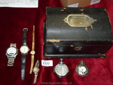 A black leather jewellery box containing ladies and gents wristwatches.