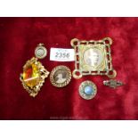 A small ornate brass picture frame, 2 1/2'' square, a brooch with picture of a young girl,