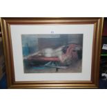 A framed and mounted Print of a reclining nude, indistinctly signed lower right.