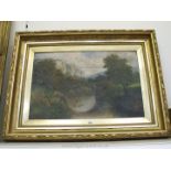 A heavy gilt framed Oil on canvas depicting a river scene with the ruins of a stone bridge spanning