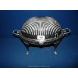 A silver plated revolving breakfast serving Dish having four spade feet and matching lid, 14" long,