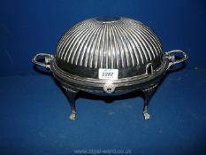A silver plated revolving breakfast serving Dish having four spade feet and matching lid, 14" long,