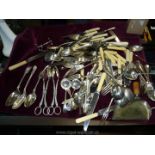 A quantity of cutlery, some plated including knives, forks, salad servers, sifter spoons etc.