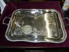 A silver plated two handled Tray having embossed centre, 24" x 15".