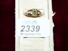 A boxed 15 ct Gold Ring set with a central green stone of vivid emerald colour and four small opals,
