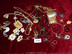 A quantity of costume jewellery including porcelain flower brooches, watch,, necklaces,