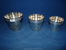 A graduated set of three silver plated jardiniere Pots, embossed with flowers.