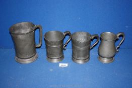 A quantity of miscellaneous Pewter Tankards including two pint tankards (dented) with marks,