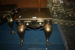 A large and heavy brass Footman with false front drawer detail and swing handles.
