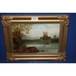 A gilt framed Oil on canvas depicting a lake scene with sailing boat and figures and a castle with