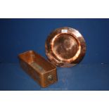 A copper flower trough with lion head handles, 14'' long and a copper plate 11 1/2'' diameter.