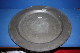 A large, heavy London Pewter Charger, 22" diameter, rubbed marks to base.