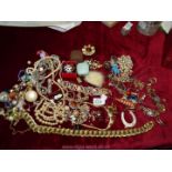 A quantity of miscellaneous costume jewellery including necklaces, brooches, hat pin etc.