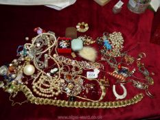 A quantity of miscellaneous costume jewellery including necklaces, brooches, hat pin etc.