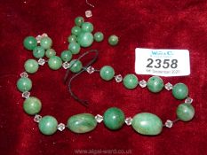A string (broken) of 27 Jade coloured beads and faceted glass beads for re-stringing.