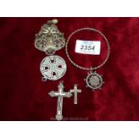 A filigree clip-on brooch, two white metal crosses,