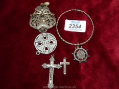 A filigree clip-on brooch, two white metal crosses,