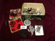 A quantity of costume jewellery necklaces, brooches, etc.