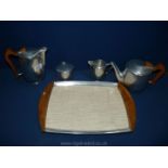 A 1960's four piece Picquot ware Teaset on a tray made of teak handled magnalium by Burrage and