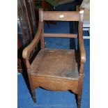 An oak commode chair.
