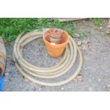 Coil of reinforced water hose and flower pots