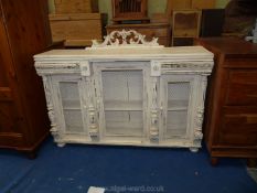 A painted buffet base with netting wire doors in Shabby Chic style, 53" long x 15" deep x 35" high.